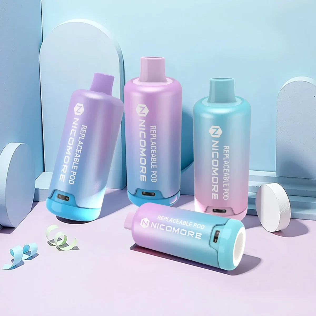 Nicomore replaceable pods in pink and blue, displayed against a minimalistic background.